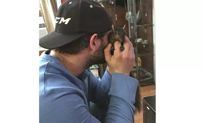 This December 2017 photo shows Mark Longo with Peanut, a squirrel who lived as a pet Longo in Southport, N.Y. (Mark Longo via AP))