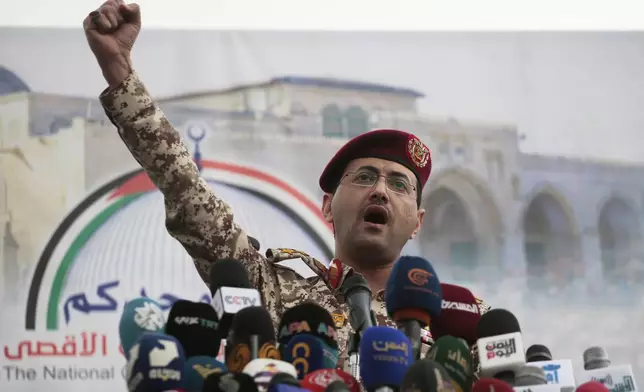 Houthi military spokesman Yahya Saree speaks at a rally against the U.S. and Israel in Sanaa, Yemen, Friday, April 18, 2025. (AP Photo/Osamah Abdulrahman)