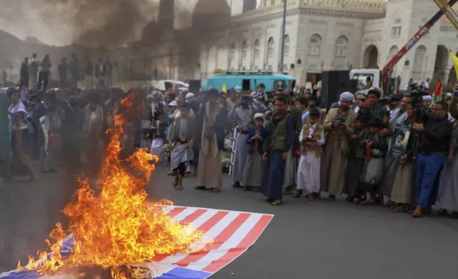Houthi supporters burn an American and an Israeli flags during an anti-U.S. and anti-Israel rally in Sanaa, Yemen, Friday, April 18, 2025. (AP Photo/Osamah Abdulrahman)