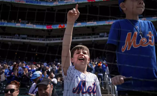 Young fans cheer at a baseball game between the New York Mets and the St. Louis Cardinals, Sunday, April 20, 2025, in New York. (AP Photo/Angelina Katsanis)