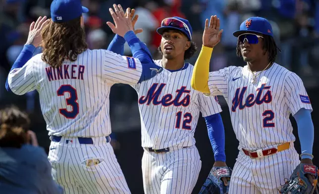 New York Mets' Jesse Winker, Francisco Lindor and Luisangel Acuña celebrate winning the baseball game 7-4 against the St. Louis Cardinals, Sunday, April 20, 2025, in New York. (AP Photo/Angelina Katsanis)