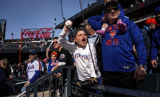 A young fan shouts, "Can you sign my ball?" to New York Mets players after a baseball game against the St. Louis Cardinals, Sunday, April 20, 2025, in New York. (AP Photo/Angelina Katsanis)