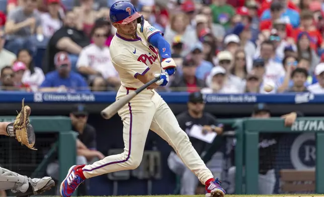 Philadelphia Phillies' Trea Turner hits an RBI single during the third inning of a baseball game against the Miami Marlins, Saturday, April 19, 2025, in Philadelphia. (AP Photo/Laurence Kesterson)