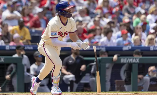 Philadelphia Phillies' Bryce Harper follows through on an RBI double during the first inning of a baseball game against the Miami Marlins, Sunday, April 20, 2025, in Philadelphia. (AP Photo/Laurence Kesterson)