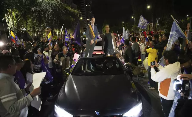 Supporters of President Daniel Noboa celebrate early returns showing him in the lead in the presidential election runoff in Quito, Ecuador, Sunday, April 13, 2025. (AP Photo/Carlos Noriega)