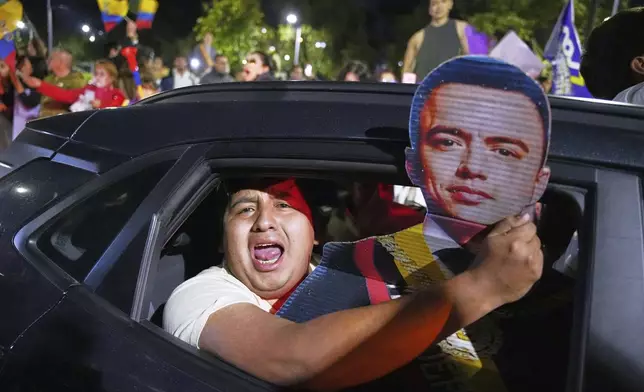 Supporters of President Daniel Noboa celebrate early returns showing him in the lead in the presidential election runoff in Quito, Ecuador, Sunday, April 13, 2025. (AP Photo/Carlos Noriega)