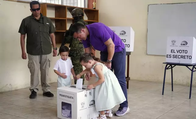 Incumbent presidential candidate Daniel Noboa casts his vote, accompanied by his children, in the election runoff in Olon, Ecuador, Sunday, April 13, 2025. (AP Photo)