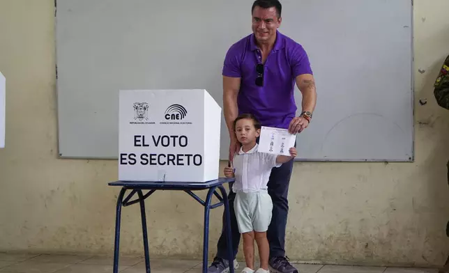 Incumbent President Daniel Noboa shows his ballot casts before voting, accompanied by his children, in the presidential election runoff in Olon, Ecuador, Sunday, April 13, 2025. (AP Photo)