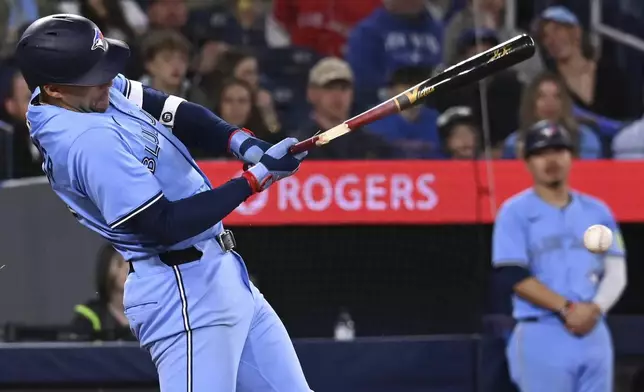 Toronto Blue Jays' George Springer (4) breaks his bat on a ground out against the Seattle Mariners in the fourth inning of a baseball game in Toronto on Sunday, April 20, 2025. (Jon Blacker/The Canadian Press via AP)