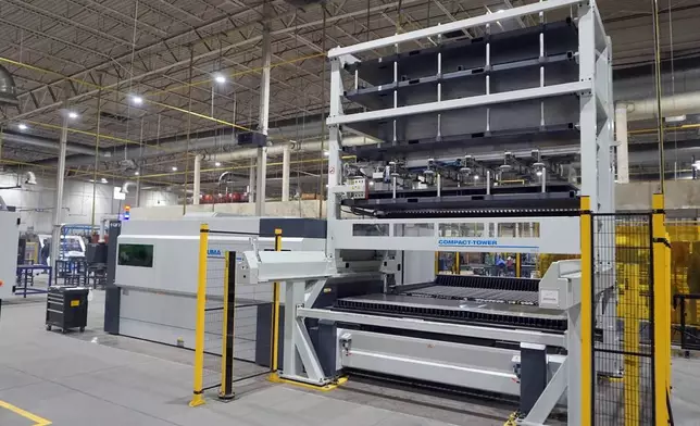 Automated laser cutting system and material storage tower in Komacut’s Mexico facility, designed for high-volume precision manufacturing.