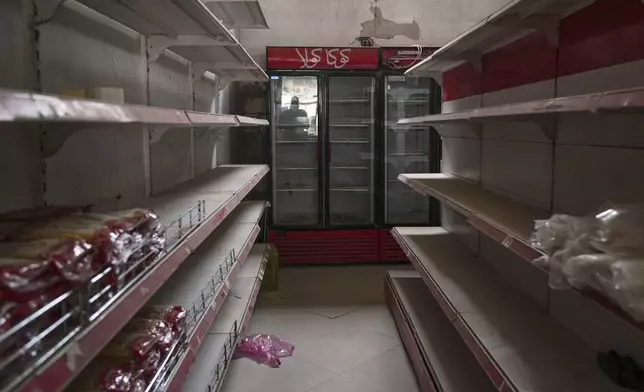 Empty shelves are seen at Al-Tayyibat supermarket in Khan Younis, in the southern Gaza Strip, Thursday, April 24, 2025, amid ongoing food shortages. (AP Photo/Abdel Kareem Hana)