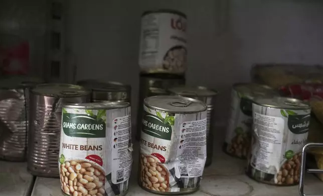 Damaged cans of white beans are displayed for sale on a shelf at Al-Tayebat supermarket in Khan Younis, in the southern Gaza Strip, Thursday, April 24, 2025. (AP Photo/Abdel Kareem Hana)