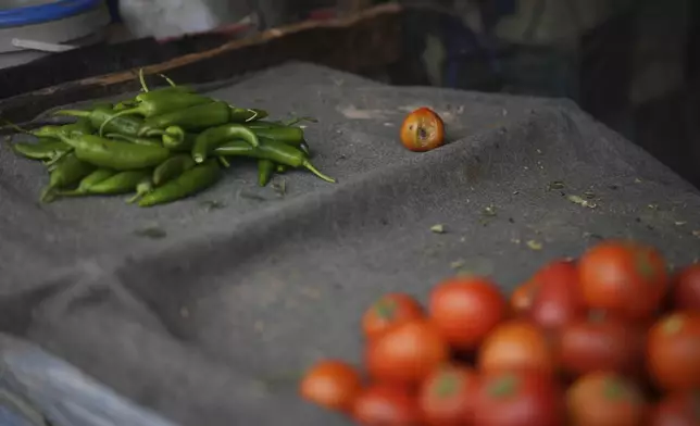 Green chili peppers are displayed for sale at an outdoor food market in Khan Younis, in the southern Gaza Strip, Thursday, April 24, 2025. (AP Photo/Abdel Kareem Hana)
