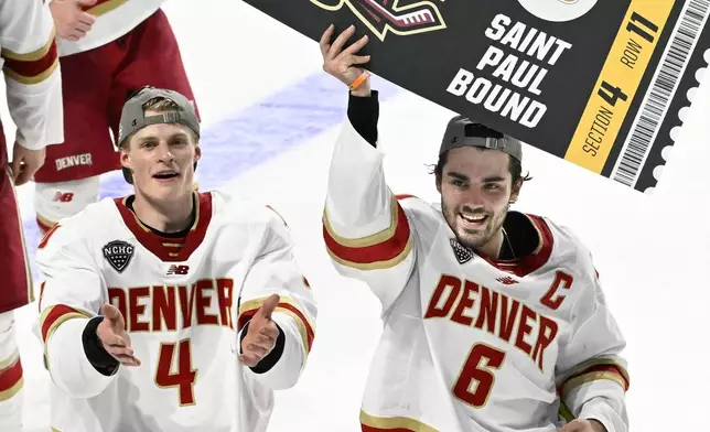 FILE - Denver forward McKade Webster (6) holds up a Frozen Four ticket while celebrating with Jack Devine (4) at the end of an NCAA men's college hockey tournament regional final against Cornell in Springfield, Mass., Saturday, March 30, 2024. (AP Photo/Jessica Hill, File)
