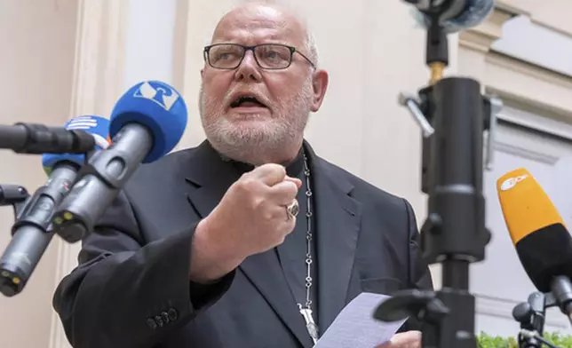 FILE - Cardinal Reinhard Marx, Archbishop of Munich and Freising, gives a statement to the press in the courtyard of his residence in Munich, Friday, June 4, 2021. (Peter Kneffel/dpa via AP, File)