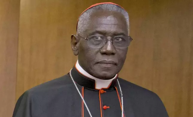 FILE - Cardinal Robert Sarah appears for the presentation of Cardinal Raymond Leo Burke's book Divine Love Made Flesh, in Rome, on Oct. 14, 2015. (AP Photo/Andrew Medichini, File)