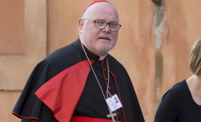 FILE - German Cardinal Reinhard Marx arrives for a morning session of a two-week synod on family issues at the Vatican, o, Oct. 6, 2014. (AP Photo/Alessandra Tarantino, File)