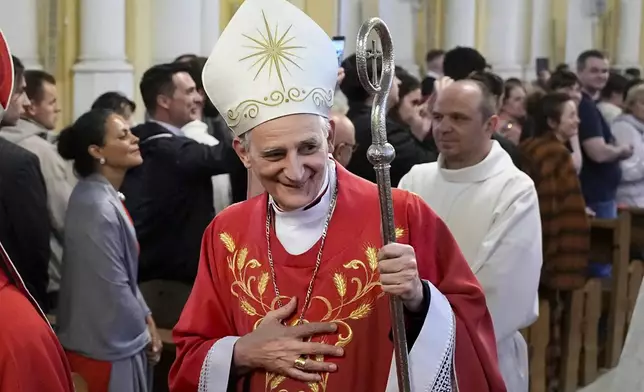 FILE - Cardinal Matteo Zuppi, head of the CEI (Italian Conference of Bishops), welcomes parishioners after celebrating Mass at the Cathedral of the Immaculate Conception in Moscow, on June 29, 2023. (AP Photo/Alexander Zemlianichenko, File)