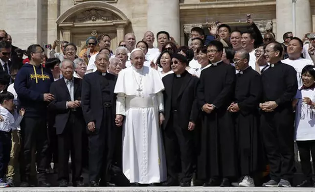 FILE - Pope Francis poses a group of faithful and bishops from Shanghai during his weekly general audience in St. Peter's square at the Vatican Wednesday, May 22, 2019. (AP Photo/Alessandra Tarantino, File)