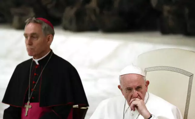 FILE - Pope Francis, flanked by Monsignor Georg Gaenswein, listens to a faithful's speech on the occasion of an audience in the Paul VI hall at the Vatican, Friday, March 22, 2019. (AP Photo/Gregorio Borgia, file)