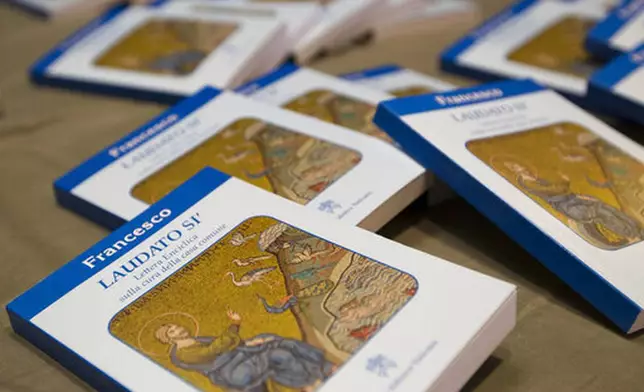 FILE - Copies of Pope Francis' encyclical "Laudato Si," (Praise Be) are displayed prior to the start of a press conference, at the Vatican, Thursday, June 18, 2015. (AP Photo/Andrew Medichini, file)