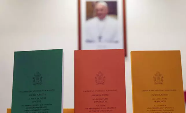 FILE - Copies of the post-synodal apostolic exhortation ' Amoris Laetitia ' (The Joy of Love) document by Pope Francis are on display prior to the start of a press conference, at the Vatican, Friday, April 8, 2016. (AP Photo/Andrew Medichini, file)