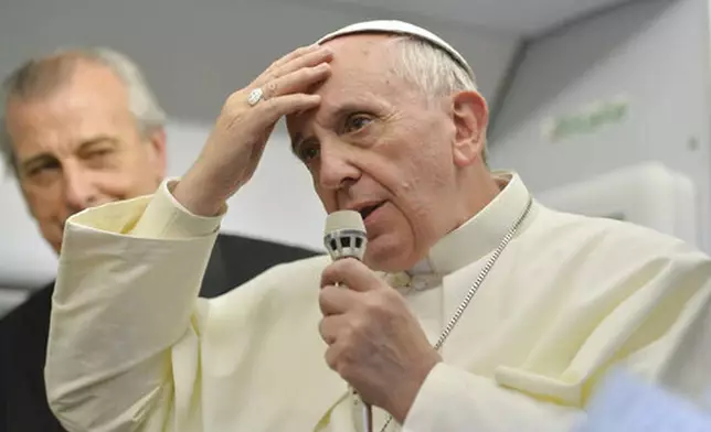 FILE - Pope Francis speaks during a news conference aboard the papal flight on its way back from Brazil, where he famously uttered "Who am I to judge?" when asked about a Vatican monsignor who purportedly had a gay lover in his past, Monday, July 29, 2013. (AP Photo/Luca Zennaro, Pool, file)