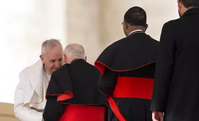 FILE - In this Feb. 19, 2014 file photo, Pope Francis greets U.S. cardinal Theodore Edgar McCarrick at the end of his general audience, in St. Peter's Square at the Vatican. (AP Photo/Alessandra Tarantino, file)