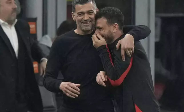 AC Milan's head coach Sergio Conceicao and Alessandro Florenzi celebrate after the Italian Cup semifinal second leg soccer match between Inter Milan and AC Milan at the San Siro stadium in Milan, Italy, Wednesday, April 23, 2025. (AP Photo/Luca Bruno)