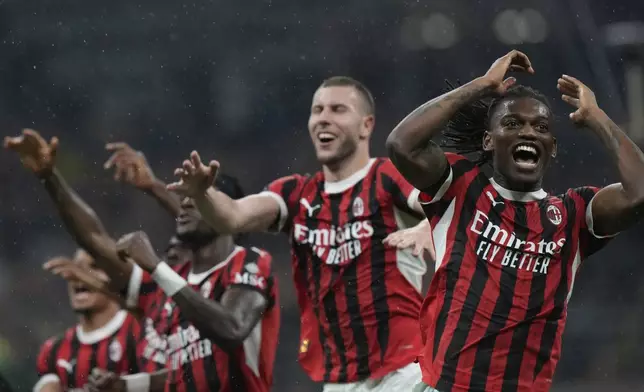 AC Milan players celebrate after the Italian Cup semifinal second leg soccer match between Inter Milan and AC Milan at the San Siro stadium in Milan, Italy, Wednesday, April 23, 2025. (AP Photo/Luca Bruno)