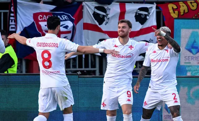 Fiorentina's Lucas Beltrán, center, celebrates scoring with teammates during the Serie A soccer match between Parma and Juventus at the Ennio Tardini Stadium, Parma, Italy, Wednesday April 23, 2025. (Gianluca Zuddas/LaPresse via AP)