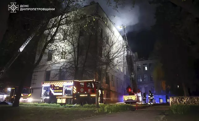 In this photo, provided by the Ukrainian Emergency Service, firefighters extinguish fire following a Russian attack in Dnipro, Thursday, April 17, 2025. (Ukrainian Emergency Service via AP)