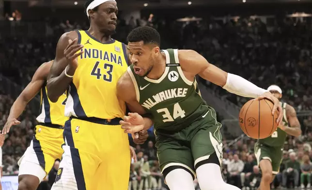 Milwaukee Bucks forward Giannis Antetokounmpo, right, drives against Indiana Pacers forward Pascal Siakam (43) during the first half in Game 3 of an NBA basketball first-round playoff series Friday, April 25, 2025, in Milwaukee. (AP Photo/Nam Y. Huh)