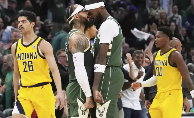 Milwaukee Bucks guard Gary Trent Jr., second from left, celebrates with forward Bobby Portis after scoring a three-point basket during the second half in Game 3 of an NBA basketball first-round playoff series against the Indiana Pacers, Friday, April 25, 2025, in Milwaukee. (AP Photo/Nam Y. Huh)