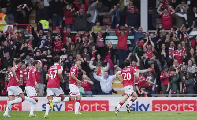 Wrexham's Oliver Rathbone, right, celebrates with teammates after scoring his side's opening goal during the English League One soccer match between Wrexham and Charlton Athletic at the Racecourse ground in Wrexham, Wales, Saturday, April 26, 2025. (AP Photo/Jon Super)