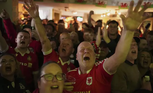 Wrexham supporters cheer prior the English League One soccer match between Wrexham and Charlton Athletic at the Racecourse ground in Wrexham, Wales, Saturday, April 26, 2025. (AP Photo/Jon Super)