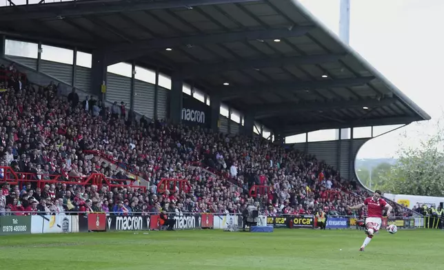 Wrexham's Matty James kicks the ball during the English League One soccer match between Wrexham and Charlton Athletic at the Racecourse ground in Wrexham, Wales, Saturday, April 26, 2025. (AP Photo/Jon Super)