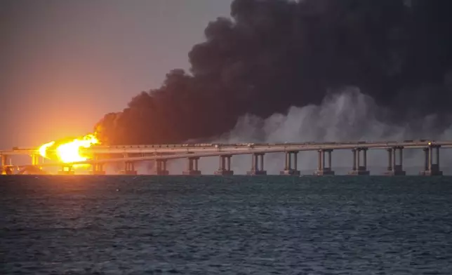 FILE - Flames and smoke rise from a bridge connecting Crimea and Russia in Kerch, on the Crimean peninsula, Oct. 8, 2022. (AP Photo, File)