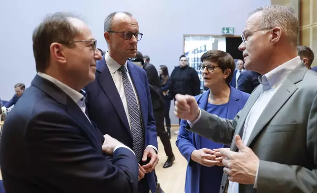 From left, Parliamentary Group Leader of the Bavarian conservative Christian Social Union (CSU) party Alexander Dobrindt, leader of Germany's Christian Democratic Union (CDU) Friedrich Merz and the co-leader of the Social Democratic Party (SPD) Saskia Esken prior to coalition talks between SPD CDU/CSU at the SPD headquarters in Berlin, Friday March 28, 2025. (Odd Andersen/Pool via AP)