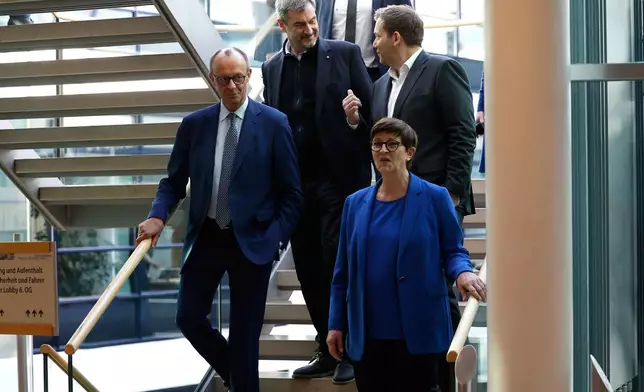 CDU leader Friedrich Merz, left, chairman of Bavarian Christian Social Union party Markus Soeder, center left, and the co-leaders of Germany's Social Democratic Party Lars Klingbeil, top right, and Saskia Esken arrive to attend coalition talks between SPD CDU/CSU at the SPD headquarters in Berlin, Friday March 28, 2025. (Odd Andersen/Pool via AP)
