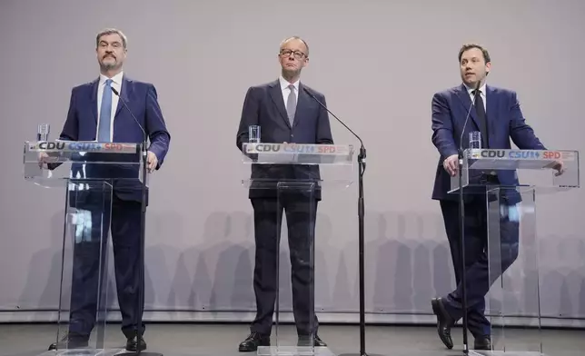 Markus Soeder, chairman of Bavarian's Christian Social Union party, Friedrich Merz, Christian Democratic Union party chairman and the Social Democratic Party co-leaders Lars Klingbeil, address the media after reaching an agreement between their parties on a coalition for a new German government at a news conference in Berlin, Germany, Wednesday, April 9, 2025. (AP Photo/Ebrahim Noroozi)