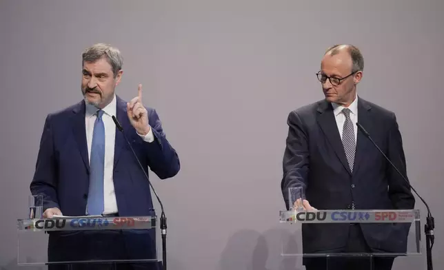Markus Soeder, chairman of Bavarian's Christian Social Union party and Friedrich Merz, Christian Democratic Union party chairman, address the media after reaching an agreement between their parties on a coalition for a new German government at a news conference in Berlin, Germany, Wednesday, April 9, 2025. (AP Photo/Ebrahim Noroozi)