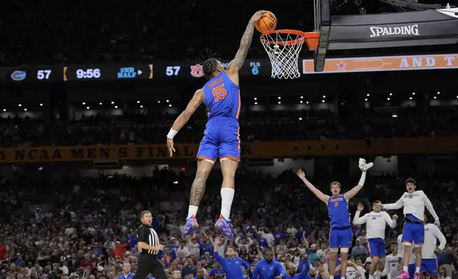 Florida's Alijah Martin (15) dunks the ball against Auburn during the second half in the national semifinals at the Final Four of the NCAA college basketball tournament, Saturday, April 5, 2025, in San Antonio. (AP Photo/Eric Gay)