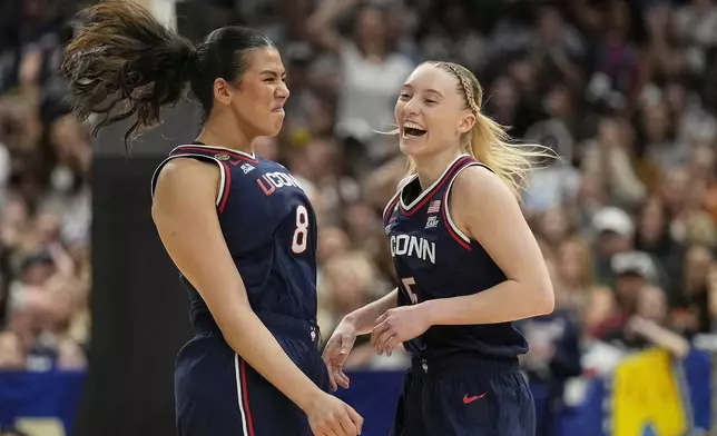 UConn center Jana El Alfy (8) and UConn guard Paige Bueckers (5) react during the first half of a national semifinal Final Four game against UCLA during the women's NCAA college basketball tournament, Friday, April 4, 2025, in Tampa, Fla. (AP Photo/Chris O'Meara)