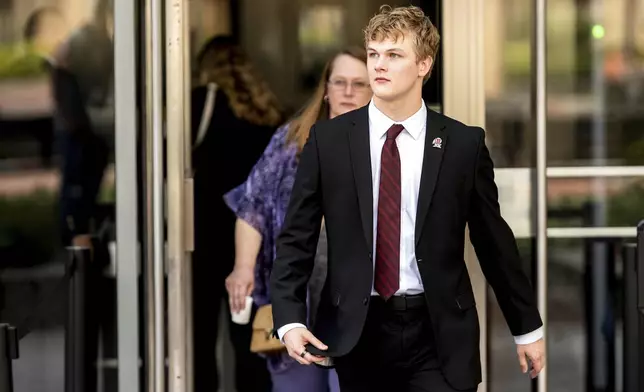 College swimmer Gannon Flynn leaves federal court during a hearing for a landmark $2.8 billion settlement impacting NCAA college athletics on Monday, April 7, 2025, in Oakland, Calif. (AP Photo/Noah Berger)