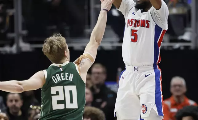 Detroit Pistons guard Malik Beasley (5) takes a shot against Milwaukee Bucks guard AJ Green (20) during the first half of an NBA basketball game Friday, April 11, 2025, in Detroit. (AP Photo/Duane Burleson)