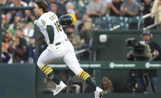 Athletics Nick Kurtz runs to first for his first career major league hit against the Texas Rangers during the first inning of a baseball game, Wednesday, April 23, 2025, in West Sacramento, Calif. (AP Photo/Scott Marshall)