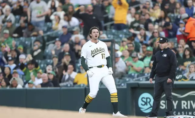 Athletics Nick Kurtz (16) celebrates his first career major league hit against the Texas Rangers during the first inning of a baseball game, Wednesday, April 23, 2025, in West Sacramento, Calif. (AP Photo/Scott Marshall)