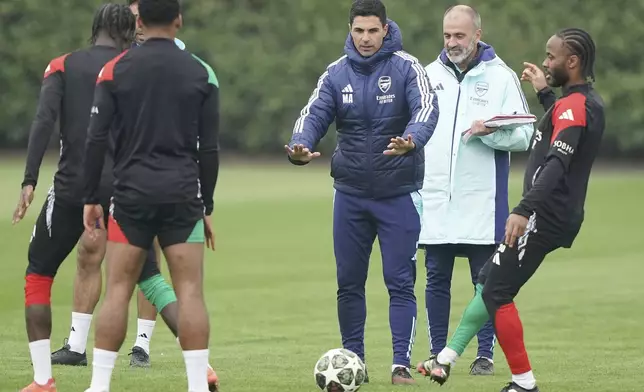 Arsenal manager Mikel Arteta, center, gestures during a training session in London, England, Tuesday, April 15, 2025, ahead of the Champions League soccer match between Real Madrid and Arsenal London. (Jonathan Brady/PA via AP)