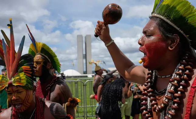 Indigenous people protest outside Congress during the annual Free Earth camp in Brasilia, Brazil, Tuesday, April 8, 2025. (AP Photo/Eraldo Peres)